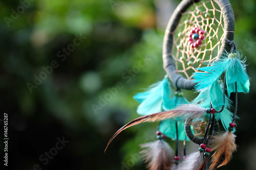 Soft focus and blurred Dream Catcher Blue Coral with natural background in vintage style. boho chic, ethnic amulet. photo