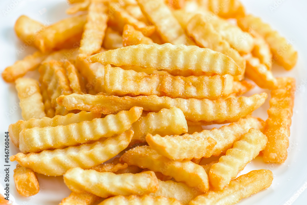 French fries with ketchup on wooden background. French fries with ketchup on wooden background.