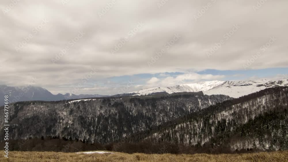 time lapse of snowy peaks with trees and mountain time lapse of snowy peaks with trees and mountain