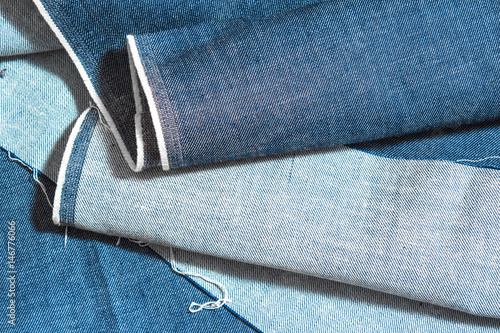 Denim blue jeans texture. Folded jeans top view. Denim jeans background close up