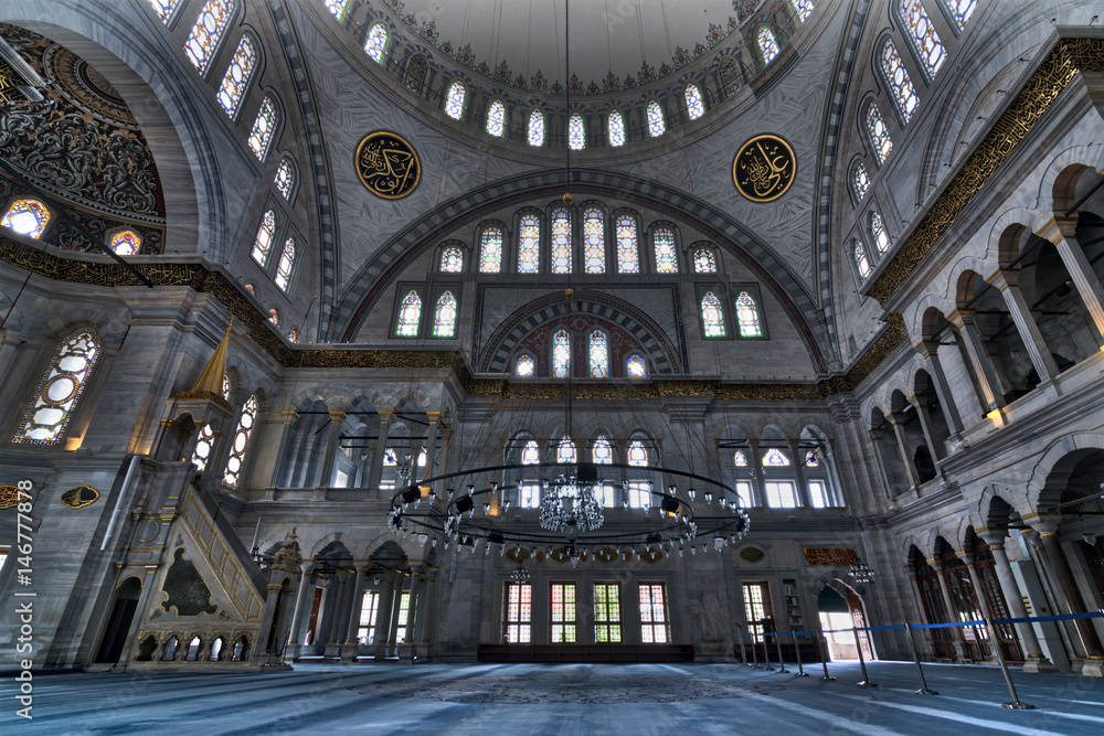 Interior of Nuruosmaniye Mosque, an Ottoman Baroque style mosque completed in 1755, with a huge dome & many colored stained glass windows located in Shemberlitash, Fatih, Istanbul, Turkey