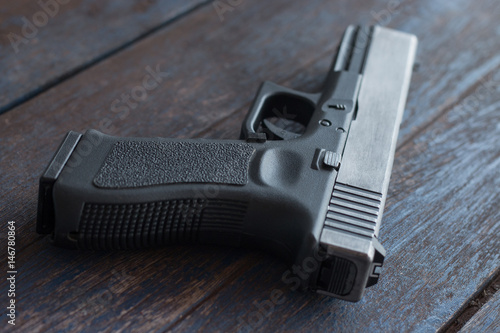 Gun handle close up on wooden background