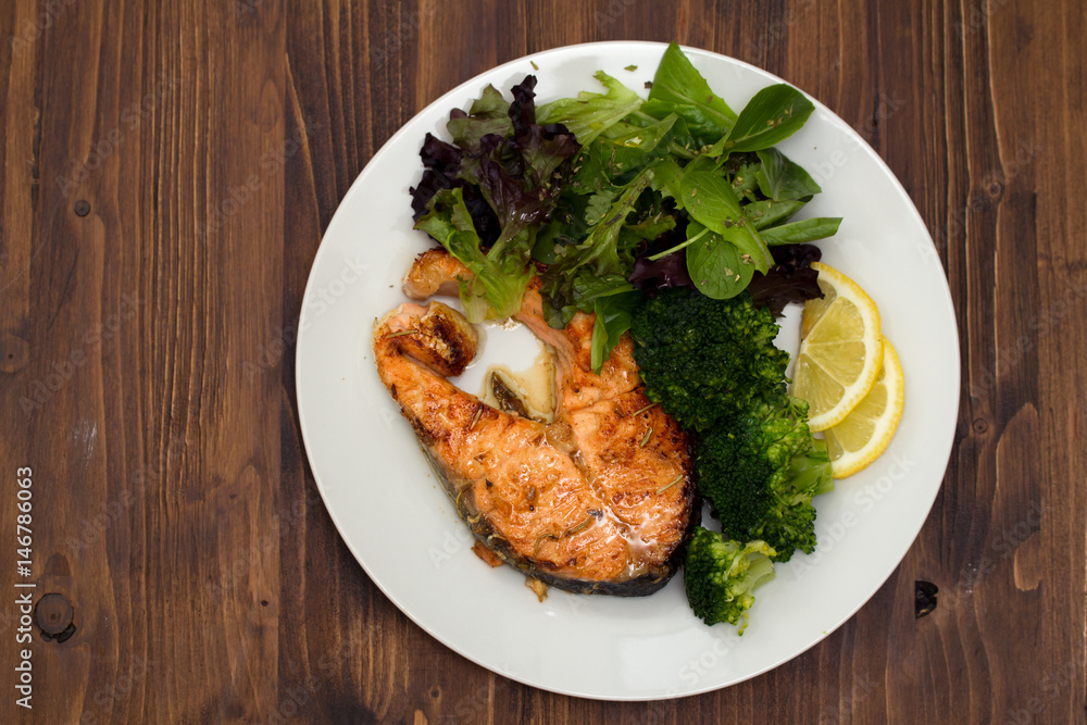 fried salmon with broccoli on dish fried salmon with broccoli on dish
