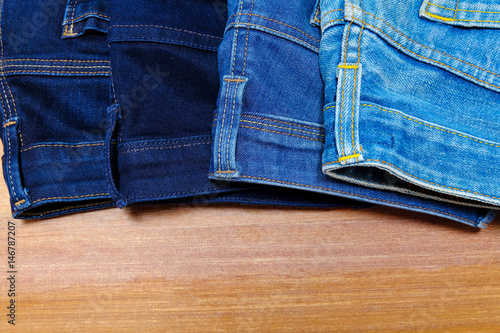 Women's denim on wooden table.