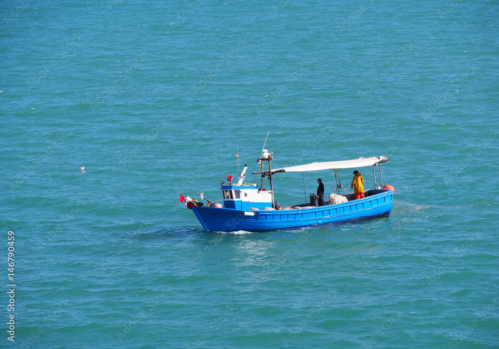 Fishing boat and fisherman in sea . Spain. 15.07.2016