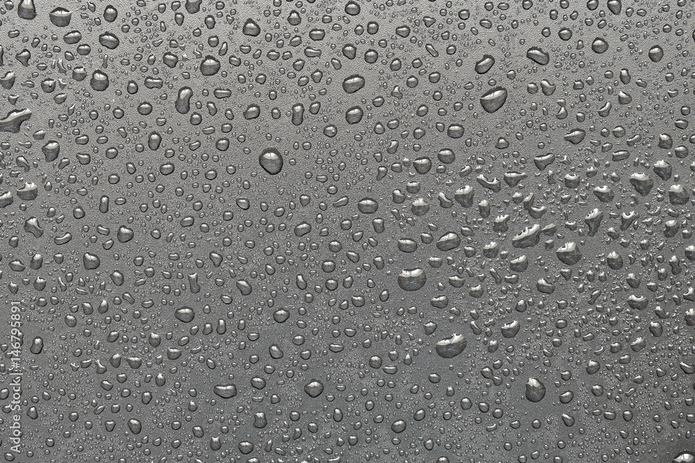 Drops of water on a black surface. The condensate. Top view. Free space. Drops of water on a black surface. The condensate. Top view. Free space.