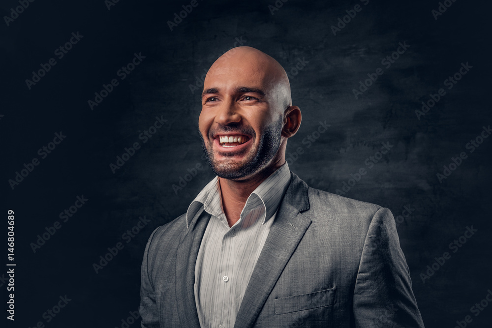 Positive shaved head male dressed in a grey suit. Positive shaved head male dressed in a grey suit.