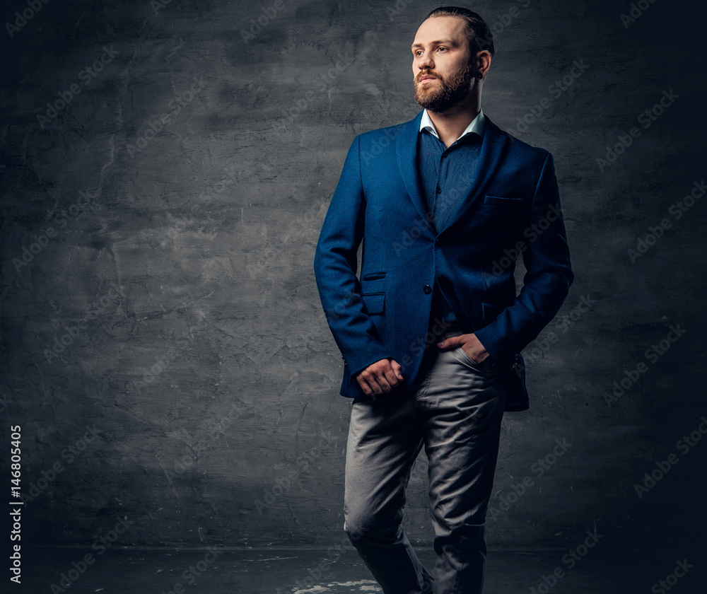 Elegant bearded male with piercing in a nose, dressed in a blue jacket. Elegant bearded male with piercing in a nose, dressed in a blue jacket.