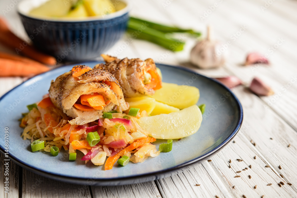 Pangasius fillets rolls stuffed with carrot and olives, served with vegetable salad and boiled potato Pangasius fillets rolls stuffed with carrot and olives, served with vegetable salad and boiled potato