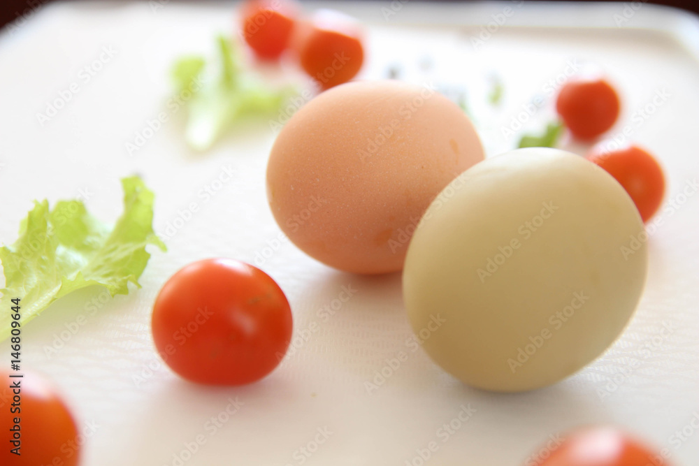 Fresh organic free range eggs with cherry tomatoes. Food design isolated on white background. Fresh organic free range eggs with cherry tomatoes. Food design isolated on white background.
