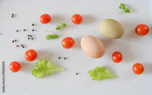 Fresh organic free range eggs with cherry tomatoes. Food design isolated on white background. 