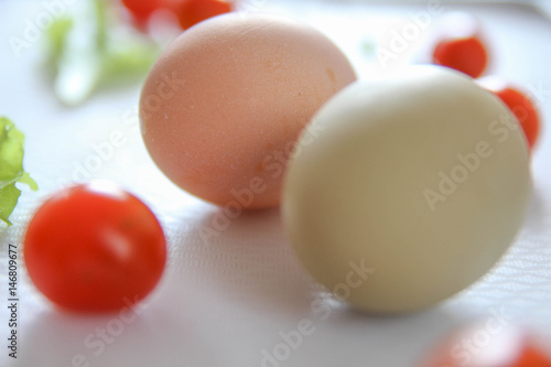 Fresh organic free range eggs with cherry tomatoes. Food design isolated on white background. 