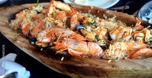 Delicious spanish meal seafood with rice served on a huge platter.