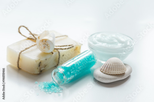 spa composition with blue sea salt and natural soap on white desk background