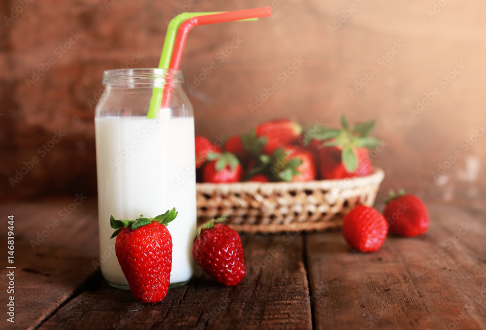 wooden table with strawberries and milk in a glass wooden table with strawberries and milk in a glass