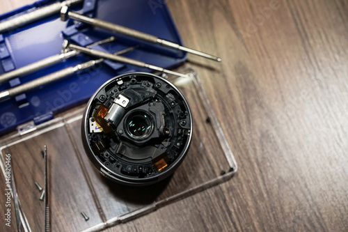 Mirrorless lens repairing. Mirrorless lens with a set of screwdrivers for opening and separate the part of the lens.