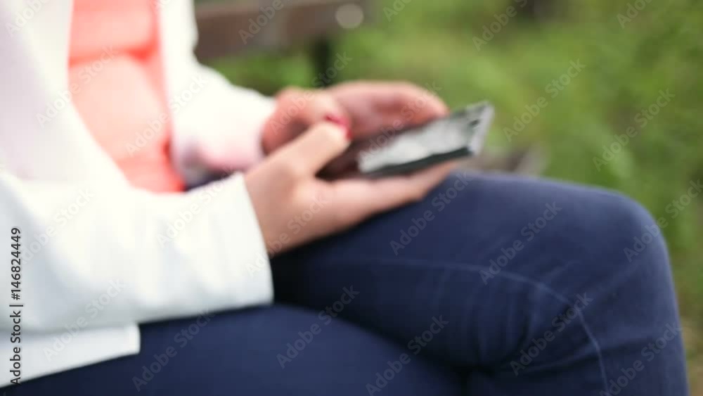 Young woman with smartphone in the park. Slide slider Young woman with smartphone in the park. Slide slider