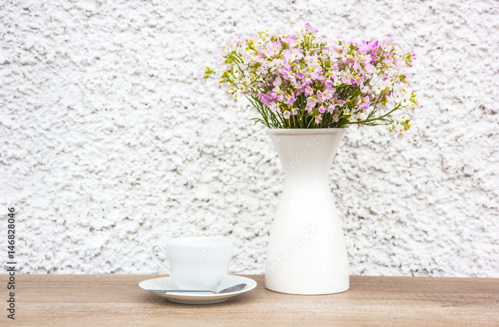White cup and vase flowers White cup and vase flowers