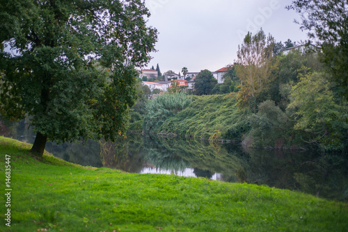 River water reflection green grass meadow tree village town landscape