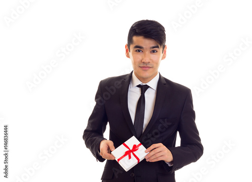 Young man in suit holding a present