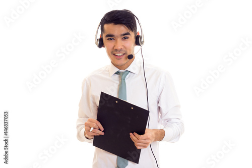 Young man using headphones and holding folder photo