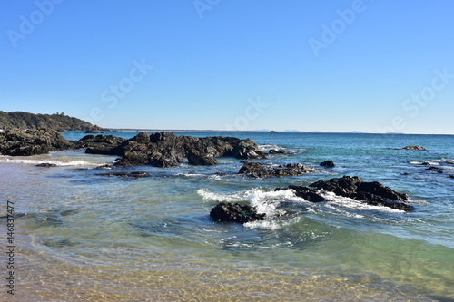 Sandy beach with dark rock formations on Nobby Beach in Port Macquarie. © Daniel Poloha