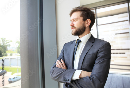 Portrait of a businessman looking at the window.
