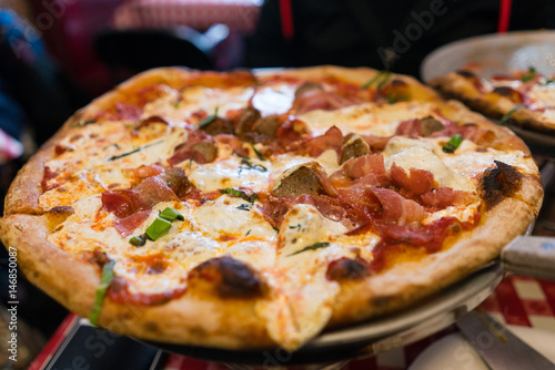 Italian thin crust pizza with meatballs and bacon