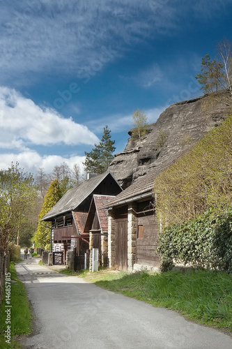 large rock above cottages in village Karba in tourist area Machuv kraj of spring czech landscape photo