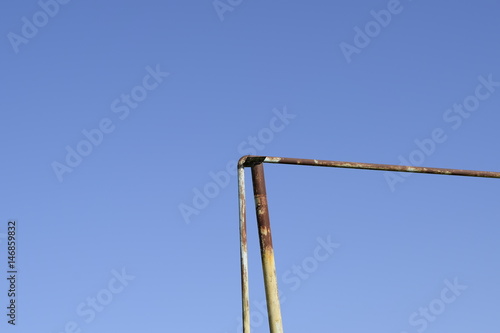 Rusty gas pipe against the blue sky