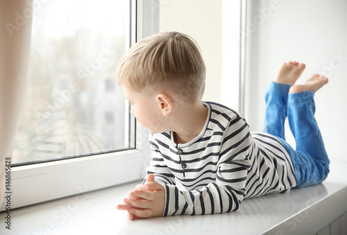 Cute little boy lying on wi...