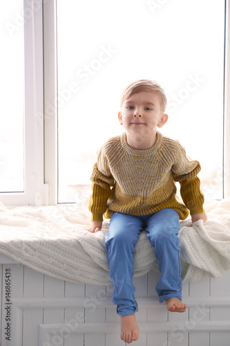 Cute little boy sitting on ...