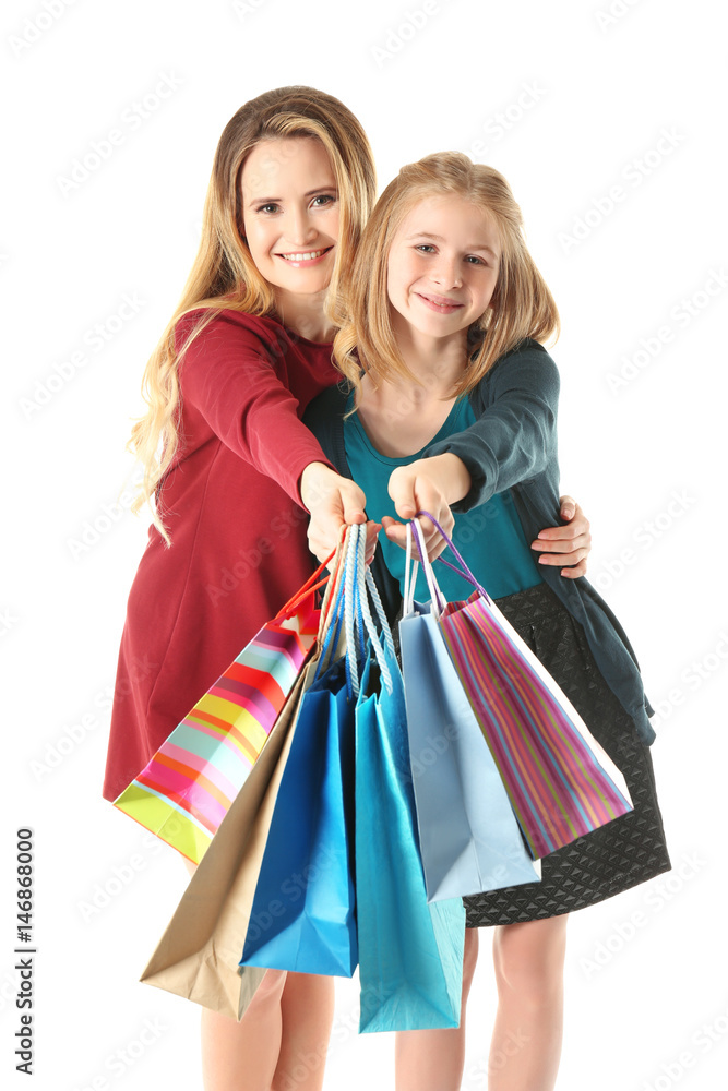 Mother and daughter with paper bags on white background Mother and daughter with paper bags on white background