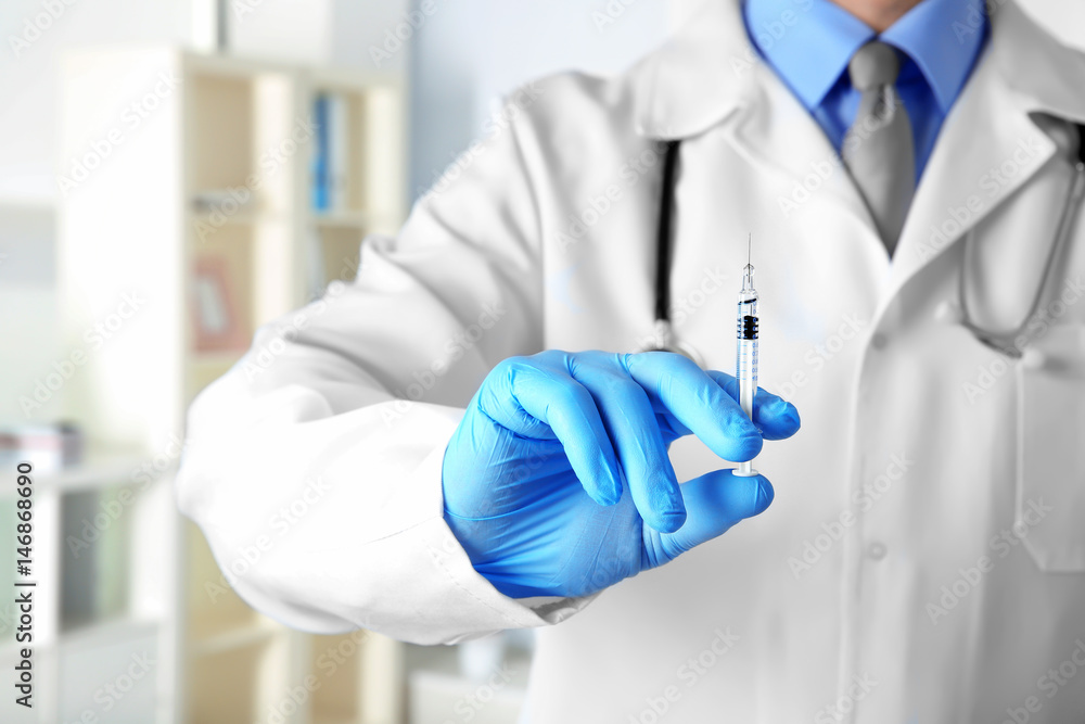 Doctor with syringe in clinic, closeup Doctor with syringe in clinic, closeup
