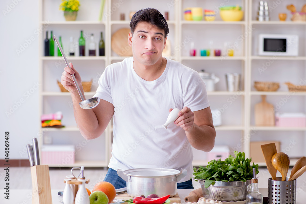 Young male cook working in the kitchen Young male cook working in the kitchen