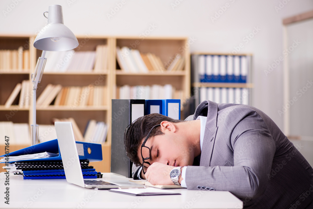 Tired businessman working in the office Tired businessman working in the office