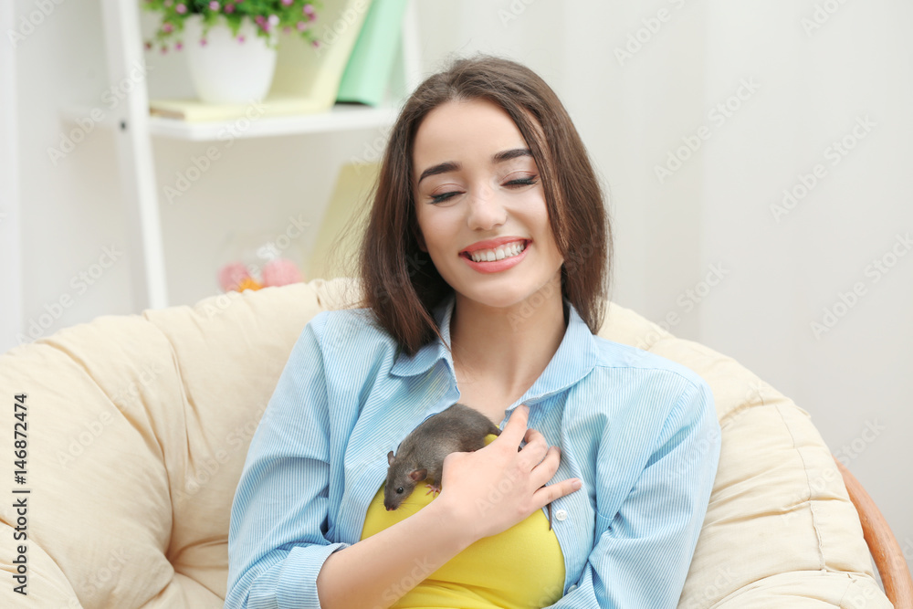 Young woman with funny rat at home Young woman with funny rat at home