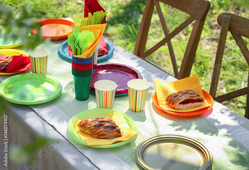 Table served with disposable tableware in garden