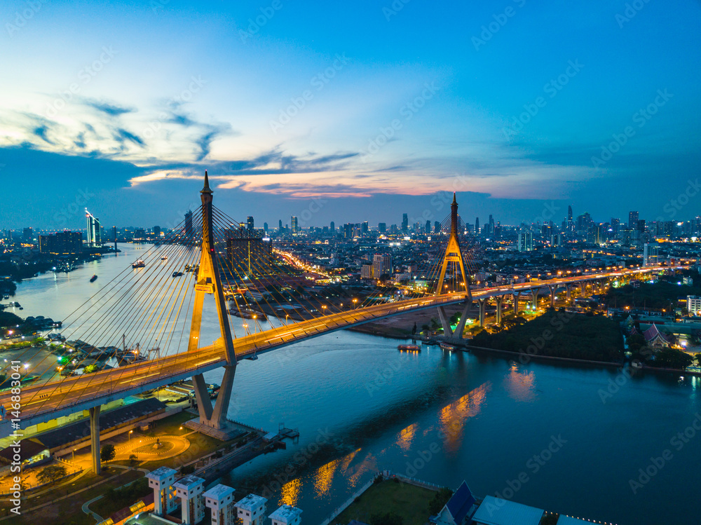 Obraz premium Beautiful sunset view from a drone of Bhumibol Bridge in Bangkok , Bridge of transportation for import , export , Bangkok ,Thailand