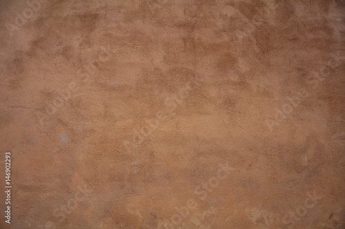Stucco painted wall background texture, brown color, exterior building facade in Italy