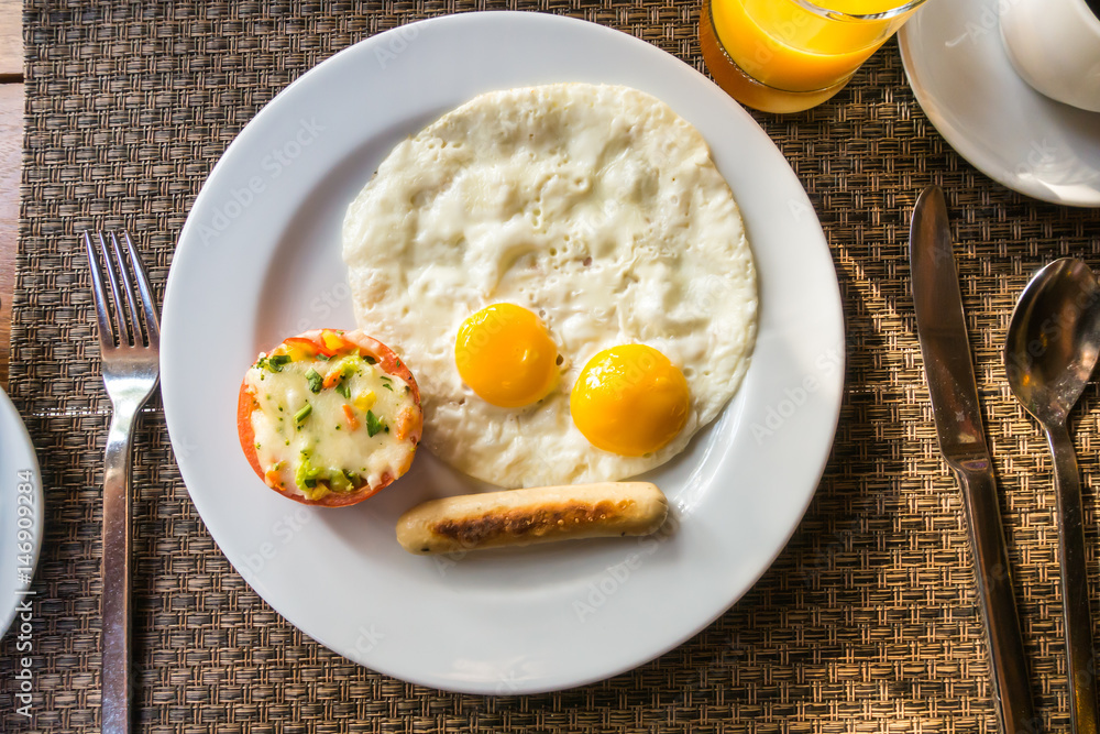Breakfast with egg and sausage . Breakfast with egg and sausage .