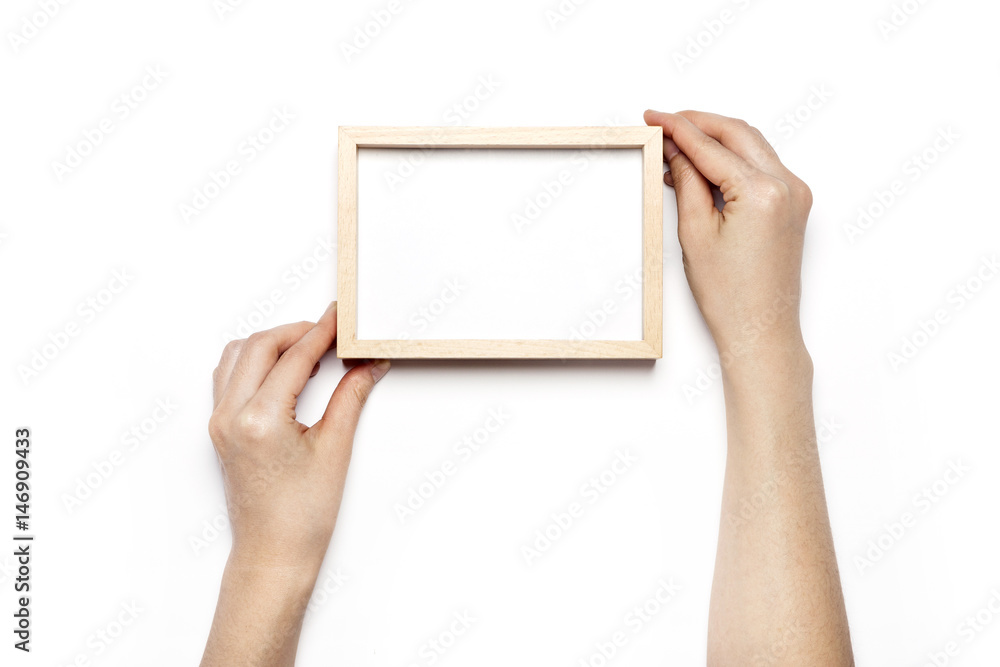 woman hand hold a white photo frame isolated white. woman hand hold a white photo frame isolated white.