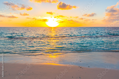 Beautiful sunset with sky over calm sea  in tropical Maldives island