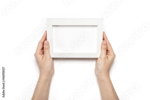 woman hand hold a white photo frame isolated white.