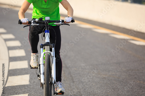 one woman cycling mountain bike on road