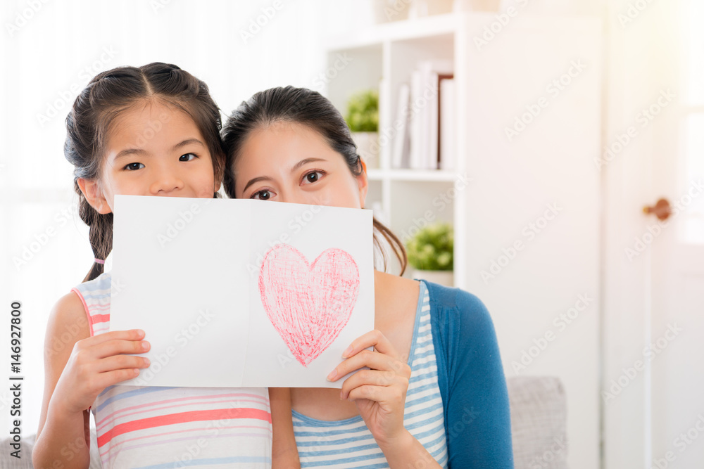 beautiful mother and youth daughter holding a card beautiful mother and youth daughter holding a card