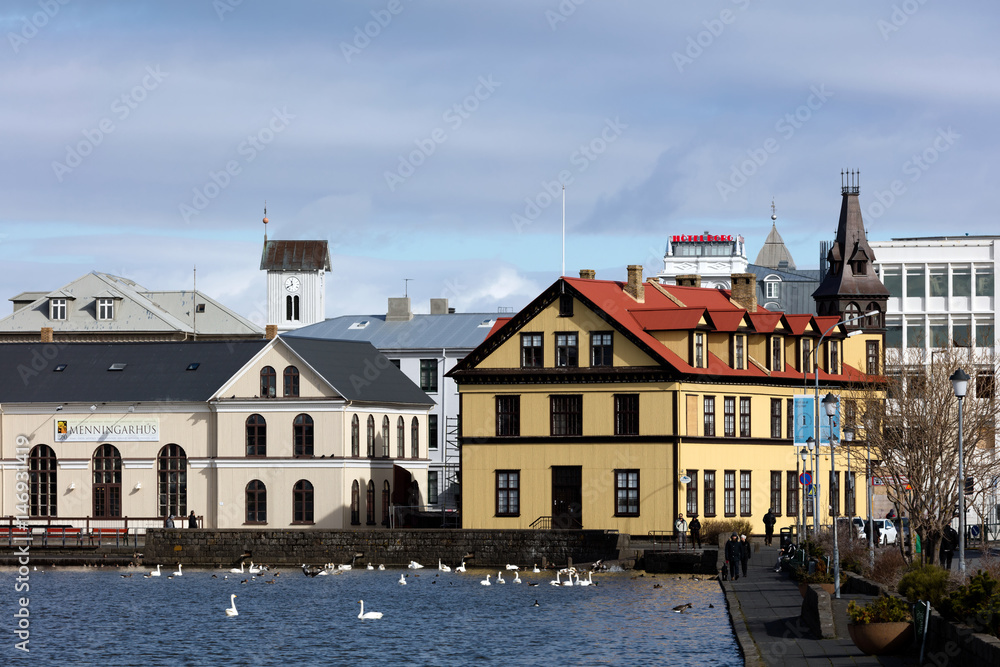 Shore of the lake Tjornin with the Tjarnarskoli building on the left.