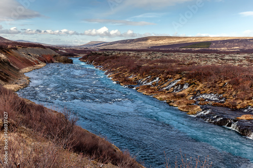 Hraunfossar in western Iceland is a series of waterfalls formed by rivulets streaming out of the Hallmundarhraun lava field.