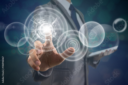 Businessman pointing the modern virtual screen over the photo blurred background, business and technology concept