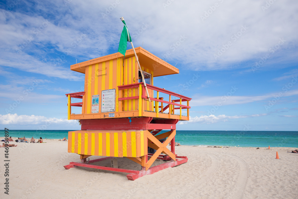 USA, FLORIDA, MIAMI BEACH. APRIL, 2017. Lifeguard tower in a colorful Art Deco style, with blue sky and Atlantic Ocean in the background. World famous travel location. South Beach. USA, FLORIDA, MIAMI BEACH. APRIL, 2017. Lifeguard tower in a colorful Art Deco style, with blue sky and Atlantic Ocean in the background. World famous travel location. South Beach.